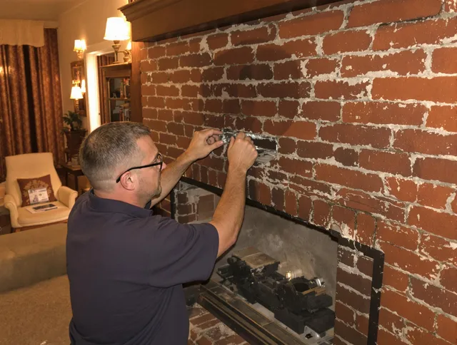 Poinciana Chimney Sweep expert fixing a fireplace in Poinciana, FL